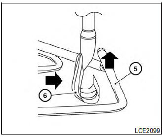 Nissan Micra. Reinstalling the temporary spare tire to its original position